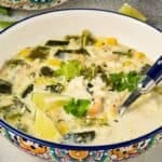 bowl on a table with Creamy Chicken Poblano Soup ready to eat
