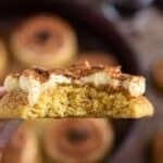 holding a Tiramisu Cookie with a bite taken out of it